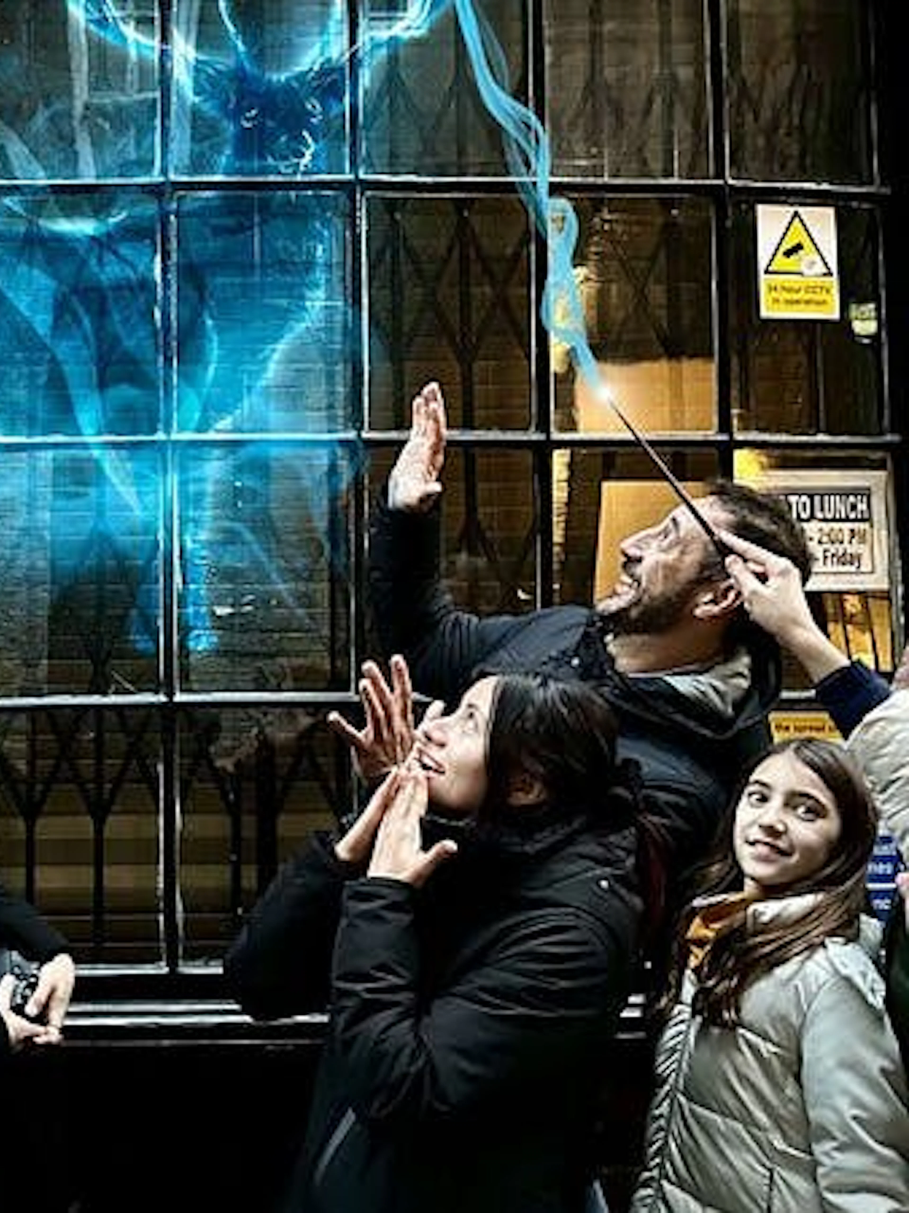 Group on Harry Potter tour in York watching a magical projection on a window.