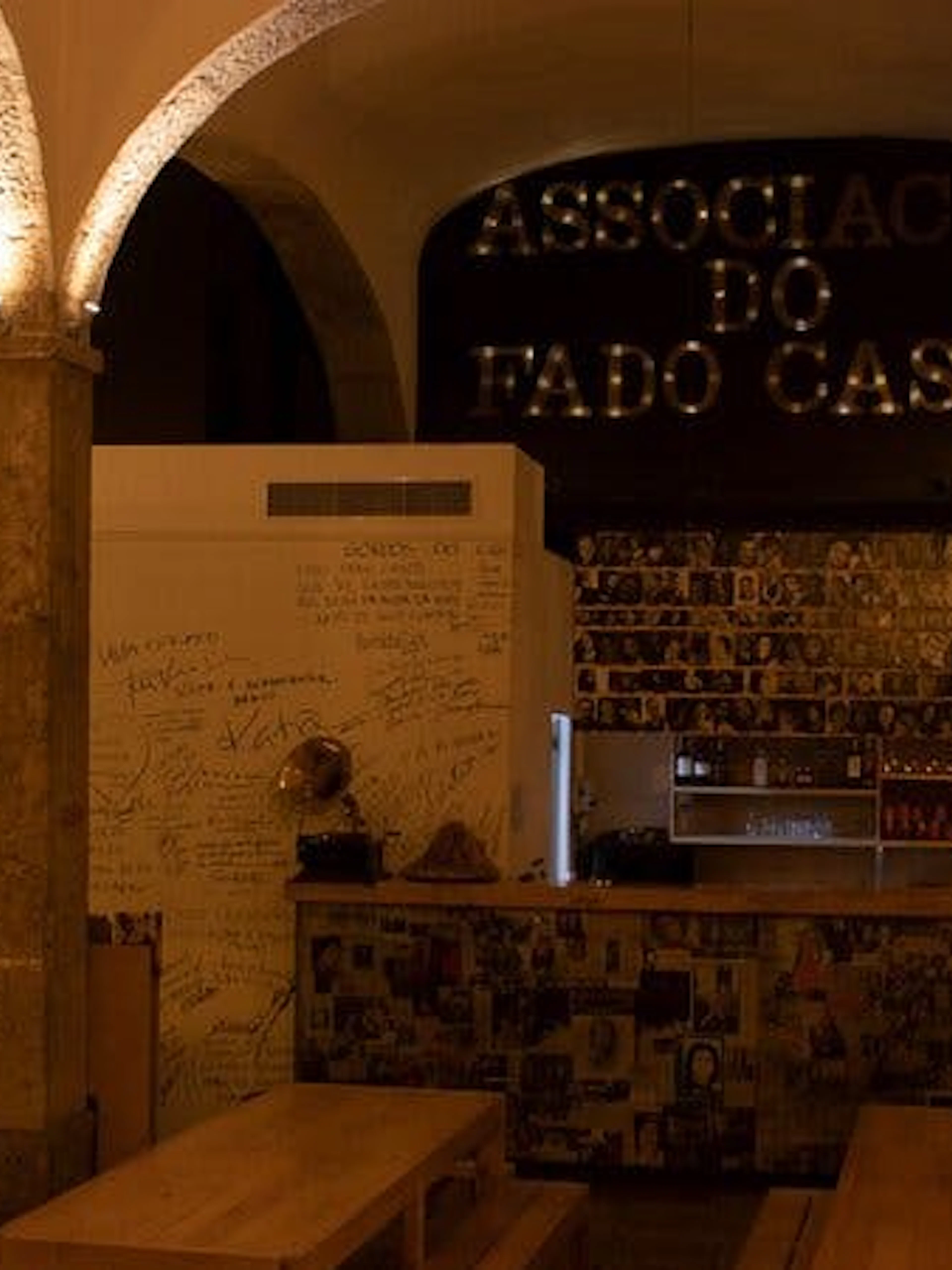Historic Roman Theatre venue interior in Lisbon with wooden tables and Fado memorabilia.