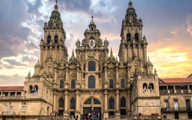 Santiago de Compostela Cathedral facade at sunset for self-guided walking tour app.