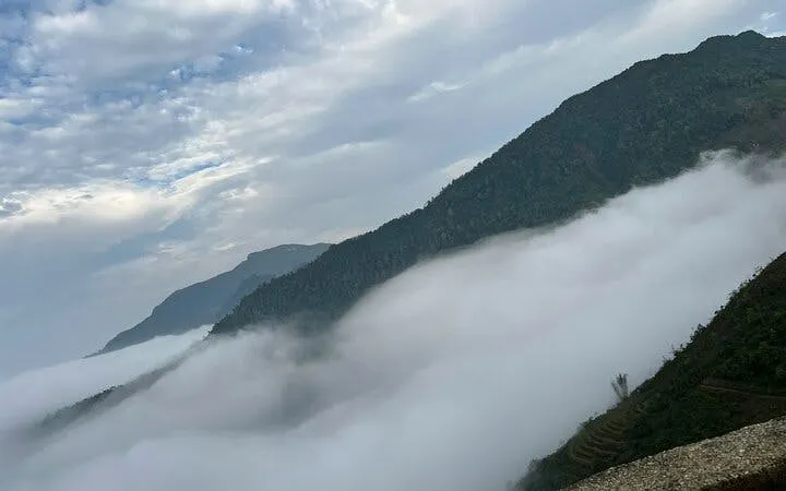 Mountain view with mist in Sapa, Vietnam, seen during a guided motorbike tour.