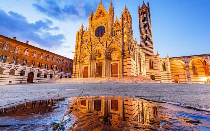 Siena Cathedral facade at sunset, featured in self-guided walking tour app.