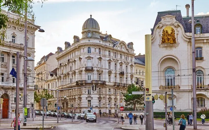 Historic architecture in Vienna city center, featuring ornate buildings on a bustling street.