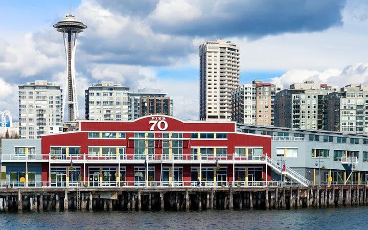 Seattle Pier 70 with Space Needle in background, part of Gold Rush city exploration game.