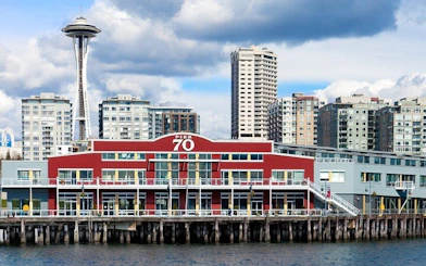 Seattle Pier 70 with Space Needle in background, part of Gold Rush city exploration game.