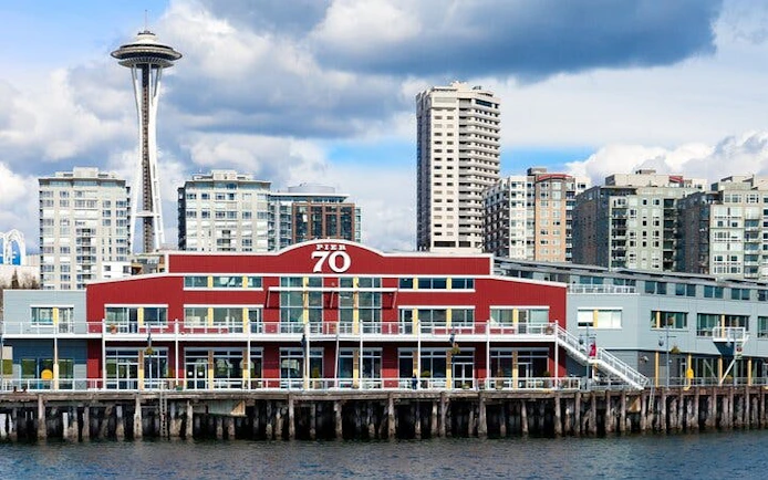 Seattle Pier 70 with Space Needle in background, part of Gold Rush city exploration game.
