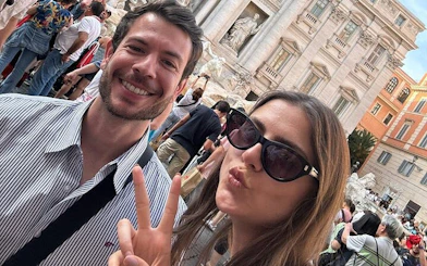 Trevi Fountain in Rome with tourists enjoying the Angels & Demons self-guided city exploration game.