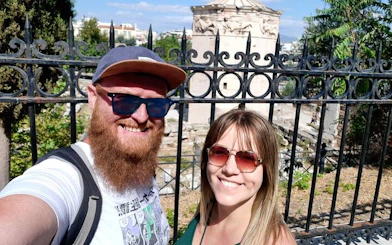 Couple in front of the Tower of the Winds in Athens during a self-guided city exploration game.