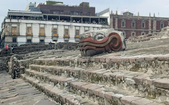 Stone serpent sculpture at Templo Mayor ruins in Mexico City Centro Histórico.