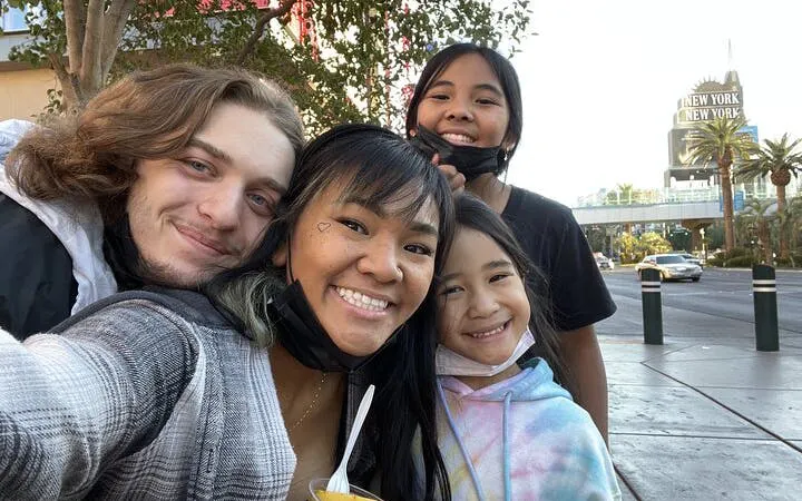 Group enjoying Las Vegas Strip with New York-New York Hotel in background.