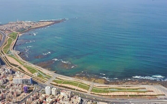 Aerial view of Casablanca coastline with cityscape and ocean, part of Marrakesh full-day excursion.