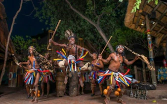Traditional dancers performing at a cultural village during Chobe Full Day Safari and Boma Dinner, Kasane.