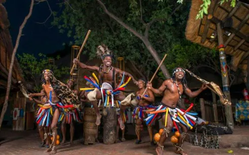 Traditional dancers performing at a cultural village during Chobe Full Day Safari and Boma Dinner, Kasane.