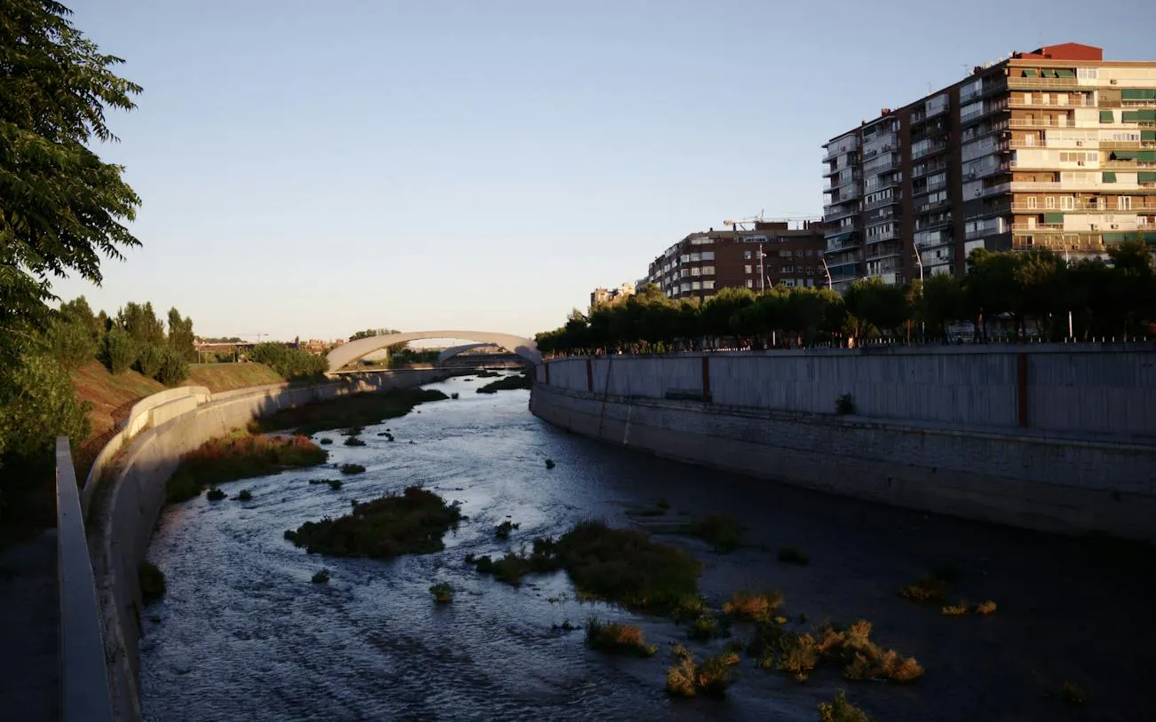 Madrid Río with Segovia Bridge and cityscape in the background.