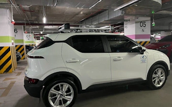 Private transfer vehicle in parking garage for Sapa to Lào Cai Train Station service.