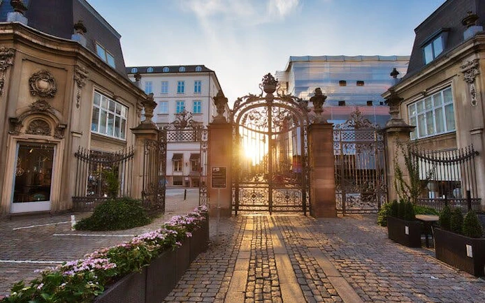 Copenhagen city gate with sunset view, part of Little Mermaid self-guided exploration game.