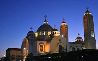 Coptic Orthodox Cathedral illuminated at dusk, Sharm El Sheikh city tour.