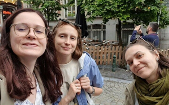 Three people exploring a street in Brussels during a self-guided city exploration game.