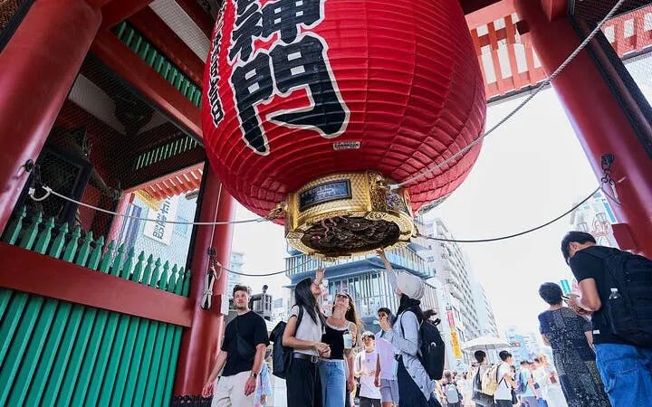 Visitors under the large red lantern at Kaminarimon Gate, Senso-ji Temple, Tokyo.
