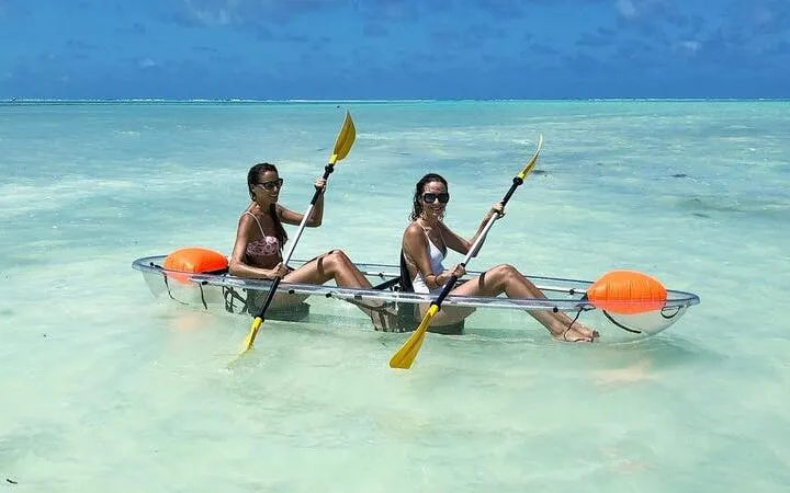 Two people kayaking in clear waters of Zanzibar, Tanzania.
