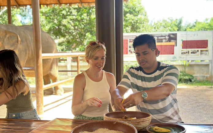 Visitors preparing food for elephants at Samui Elephant Home Nursery.