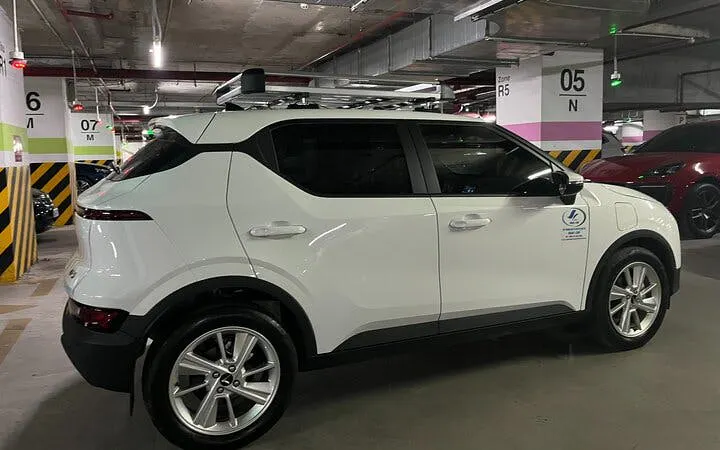 White SUV for private transfer from Sapa to Lào Cai Train Station in parking garage.