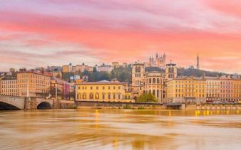 Lyon skyline with Basilica of Notre-Dame de Fourvière at sunset, viewed from the Saône River.