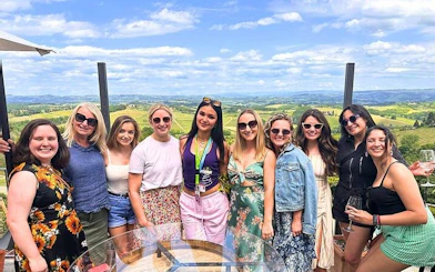 Group enjoying Chianti wineries tour with scenic vineyard views in San Gimignano.