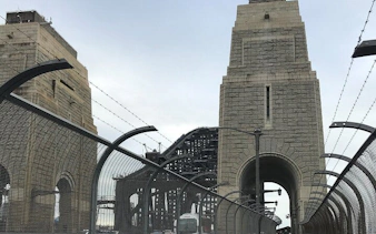 Sydney Harbour Bridge walkway with stone pylons, part of Ghosts of Sydney tour.