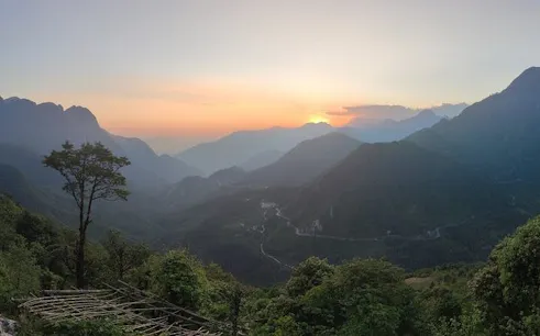 Sunset view over mountains and valleys in Sa Pa, featuring the Lonely Tree.