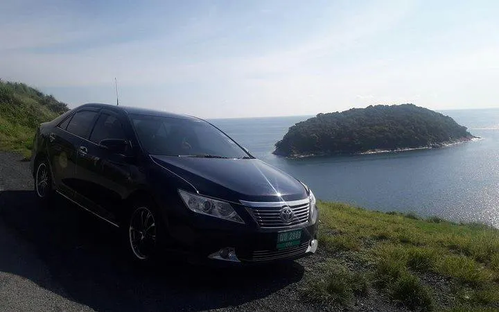 Car parked by the coast with ocean view, Phuket Airport Transfers.