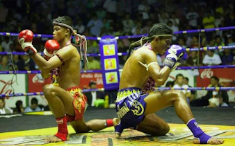 Muay Thai fighters performing pre-fight ritual at Rajadamnern Stadium, Bangkok.
