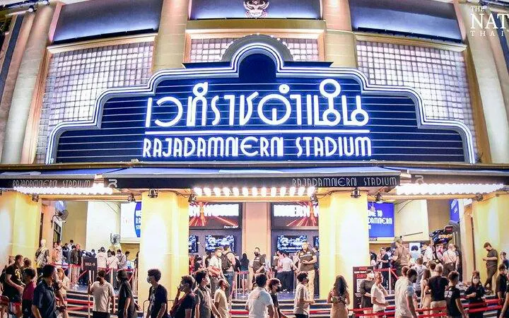 Rajadamnern Stadium entrance with crowd, Bangkok Muay Thai event.