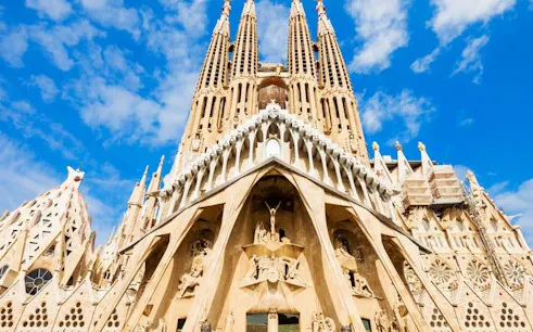 Sagrada Familia basilica facade in Barcelona on a sunny day.
