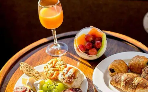 Pastries and fruit with a drink on a table during Zambezi River Classic Sunset Cruise, Victoria Falls.