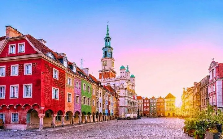 Colorful buildings in Poznan Old Market Square during sunset, featured in a self-guided audio tour.