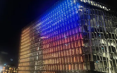 Reykjavik Harpa Concert Hall illuminated at night during private walking tour.