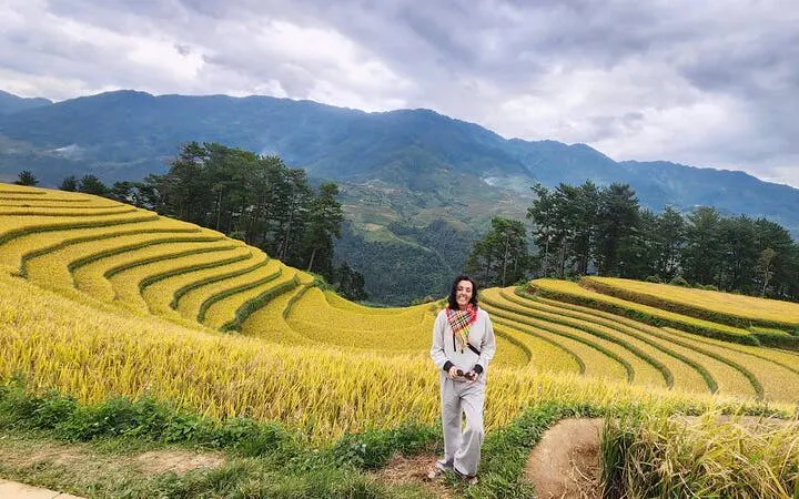 Mu Cang Chai rice terraces with traveler on motorbike tour in Northern Vietnam.
