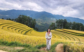 Mu Cang Chai rice terraces with traveler on motorbike tour in Northern Vietnam.