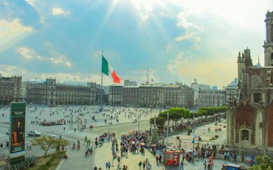 Zócalo square with Mexican flag and historic buildings, Mexico City Centro Histórico.