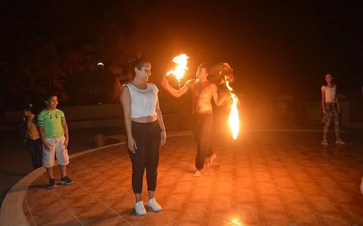 Fire performer entertaining guests during Bedouin dinner in Sharm El Sheikh.