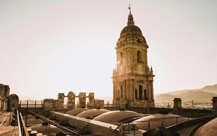 Malaga Cathedral tower at sunset during self-guided walking tour.