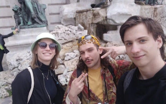Tourists enjoying a self-guided exploration game in Buda Castle District, Budapest.