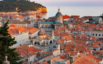 Dubrovnik Old Town rooftops with view of the Adriatic Sea and historic architecture.