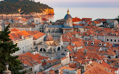 Dubrovnik Old Town rooftops with view of the Adriatic Sea and historic architecture.