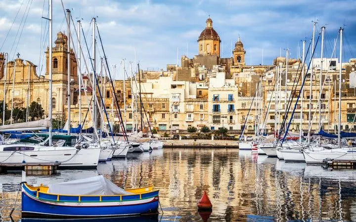 Valletta harbor with boats and historic buildings, Malta, for self-guided walking tour app.
