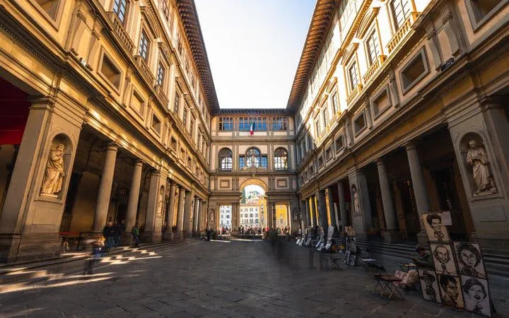 Uffizi Gallery courtyard in Florence, part of a self-guided walking tour on mobile app.