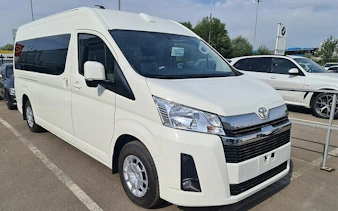 White van for personalized airport transfer service in Hurghada parking area.