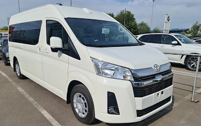 White van for personalized airport transfer service in Hurghada parking area.