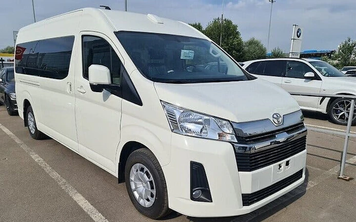 White van for personalized airport transfer service in Hurghada parking area.