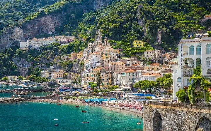 Sorrento coastline with colorful buildings and beach, viewed from the sea.